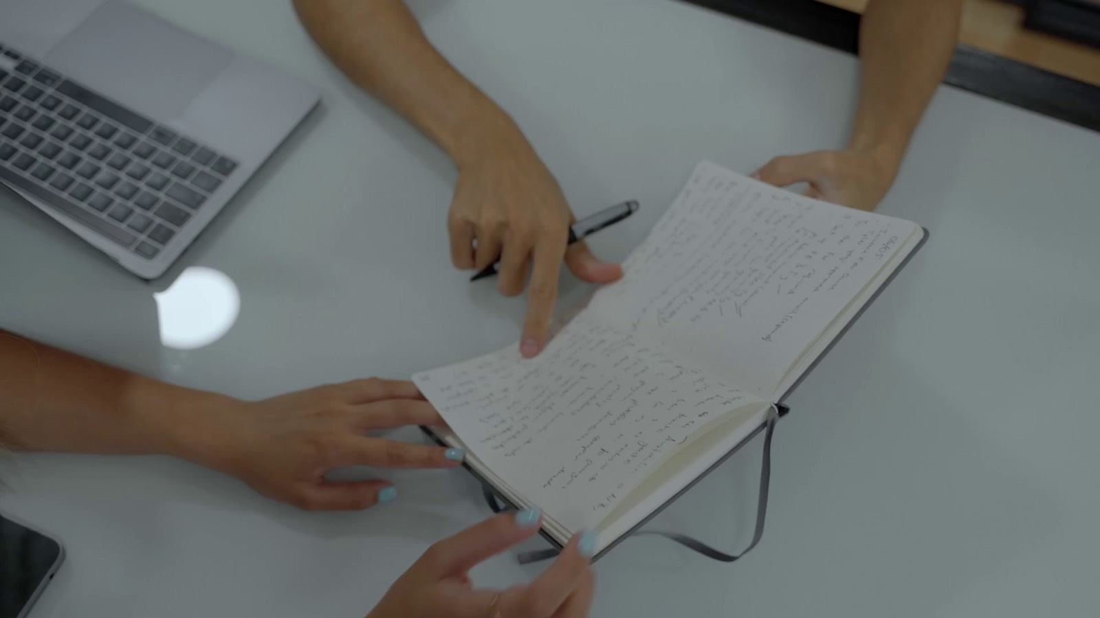 Two people reviewing notes together at a desk